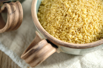 Bulgur groats in ceramic dishes