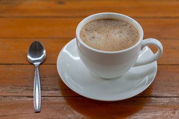 Hot coffee in a white cup on the table