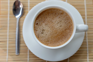 Hot coffee in a white cup on the table
