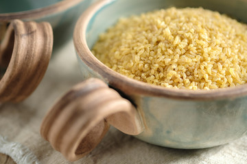 Bulgur groats in ceramic dishes