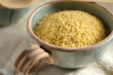 Bulgur groats in ceramic dishes