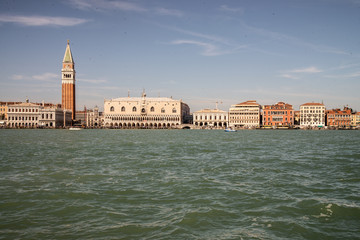 Fototapeta na wymiar Venice, Italy, view from the lagoon of the Grand Canal. San Marco basin with a view of the riva degli schiavoni, with the ducal palace, st. Bell tower of San Marco, Marciana bookshop, palace of prison