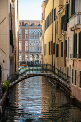 Fototapeta na wymiar View of the bridge on the Rio de l'Alboro, Venice, Italy. Iron Bridge; iron structure, iron balustrades.