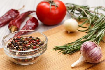 Vegetables, greens and spices for cooking meat or fish on wooden boards.