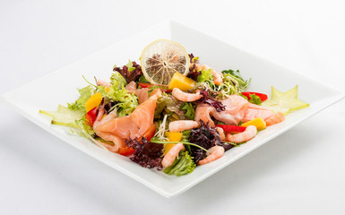Salad with salmon and shrimp. On a white background
