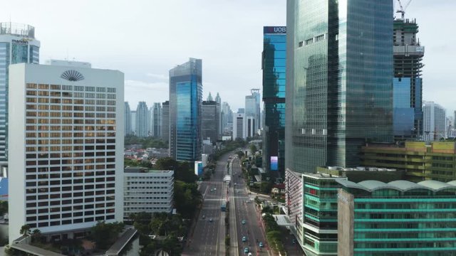 JAKARTA, Indonesia - December 28, 2018: Beautiful aerial view of skyscrapers with Sudirman road traffic and Selamat Datang Monument in Hotel Indonesia roundabout. Shot in 4k resolution