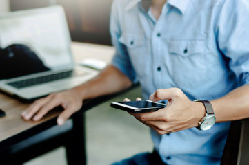 man in casual form using mobile phone at modern office