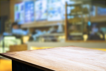Empty brown wooden table and blur background of abstract of restaurant lights  can be used for montage or display your products.