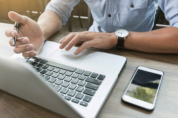 Business man working at office with laptop and documents on his desk  freelancer concept