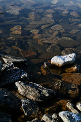 Partly submerged pebbles outstanding in the stream at Lapland Finland