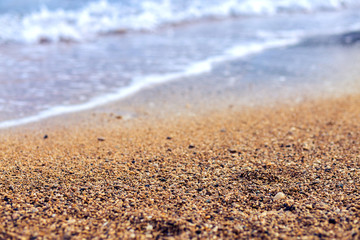 Sand on the bank of the Mediterranean Sea. Small pebble on the beach of Turkey. Sea background