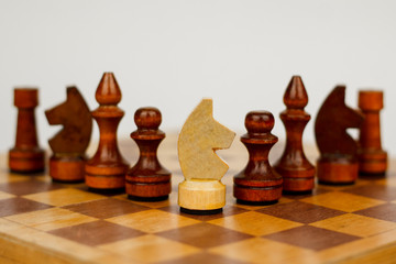 Wooden chess pieces on a chessboard