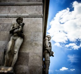 2 statues attached to the frontage of a house in budapest