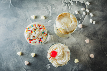 Sweet Milkshake drinks with whipped cream and marshmallows. Top view