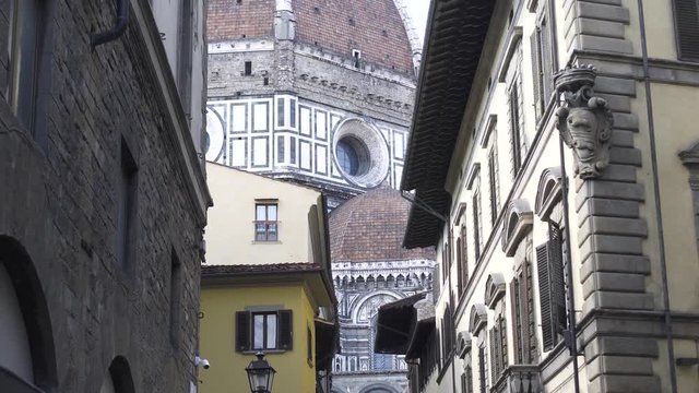 Walk trough cozy narrow streets of Florence, Duomo di Santa Maria del Fiore in the bakcground
