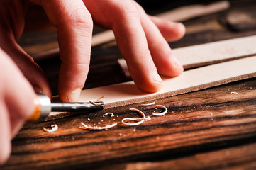 Processing products from natural leather hands close up