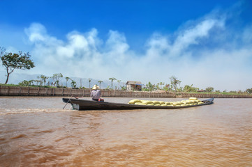 Fototapeta na wymiar Boat with yellow bags in a river on a sunny day