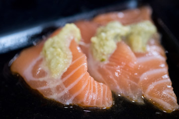 Piece salmon sashimi with wasabi