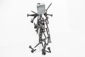 Abstract figurine of black self-tapping screws hanging on the magnet