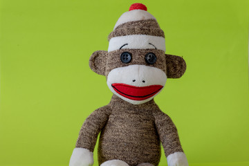 Toy monkey against green background