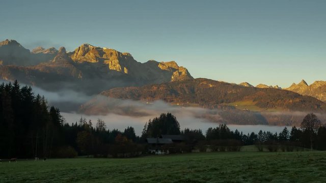 TL timelapse sunrise and morning light with fog in the valley in Pfarrwerfen