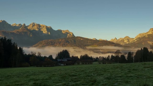 TL timelapse sunrise and morning light with fog in the valley in Pfarrwerfen