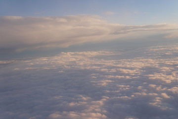 Fototapeta na wymiar clouds at sunset from iljuminatora plane sky Sun travel
