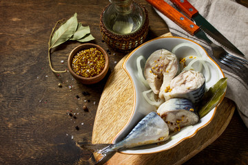 Marinated Fish. Marinated Mackerel with Spices on a wooden table. Copy space.