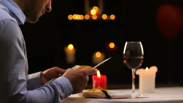 Businessman paying cash for dinner at luxury restaurant, leaving tip to waiter