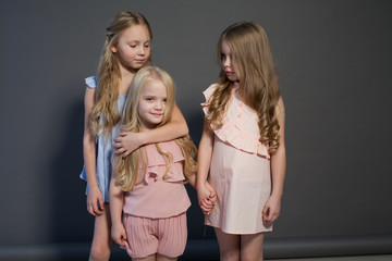 three little girls girlfriend sit together portrait