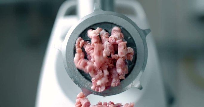 Meat grinder work on kitchen. Close up 4k footage.
