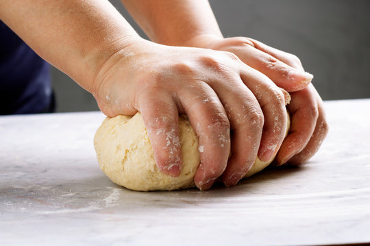 woman hands kneading dough