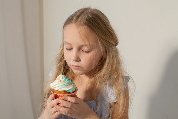 little girl eat sweet cake with cream cupcake