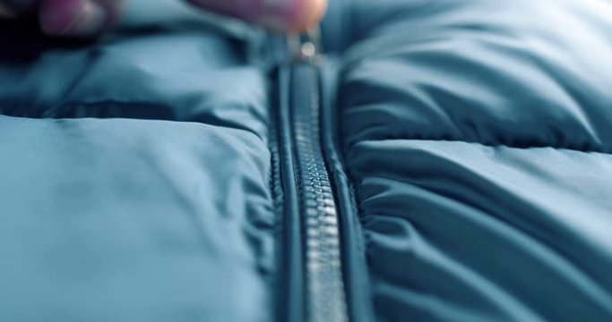 Modern close up of zipper on blue fashion clothes. 4K footage.