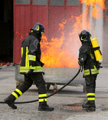 two intrepid firefighters during the exercise with a tank full o