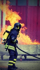 hot fire and the fireman with oxygen tanks
