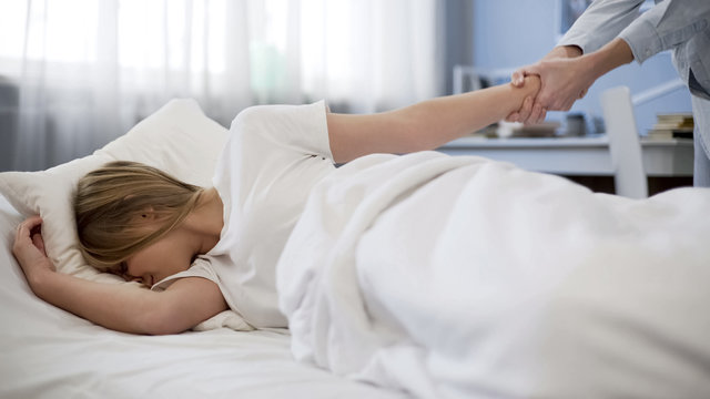 Mother pulling daughter hand trying to wake her up, late to school, problem kid