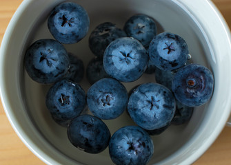Blueberries in a сup of water close-up