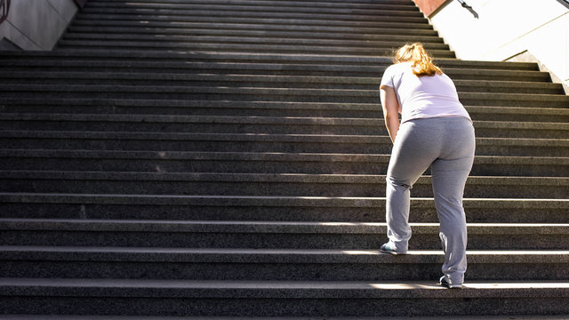 Hard to climb stairs for obese girl, victory over fatigue for goal achieving