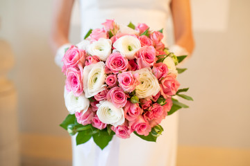 Wedding bouquet of flowers in the hands of the bride
