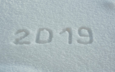 abstract winter New Year's and Christmas background from snow.text on snow 2019
