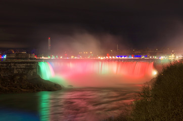 Naklejka na ściany i meble Niagara Falls at night during a winter evening in Ontario, Canada