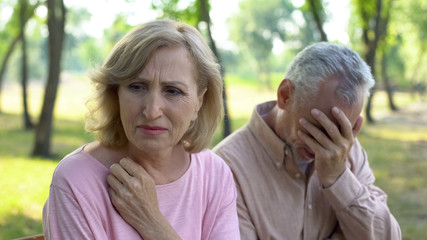 Old couple crying, frustrated with illness of close relative, problems despair