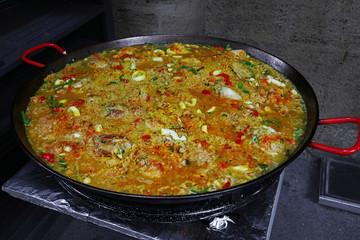Close up cooking Spanish paella in big frying pan