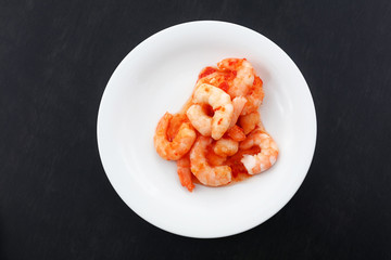 Portion of shrimps with chili sauce on plate