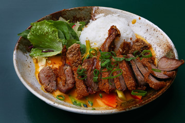 Peking duck curry with rice and salad