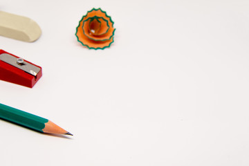 A pencil sharpener and a rubber band on a white background with a place for the inscription