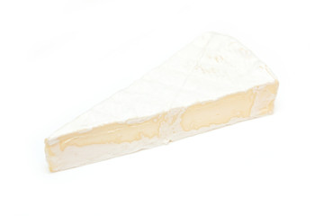 Slice of non-pasteurized brie cheese isolated on white studio background.