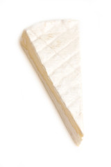 Slice of non-pasteurized brie cheese isolated on white studio background.