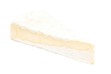 Slice of non-pasteurized brie cheese isolated on white studio background.